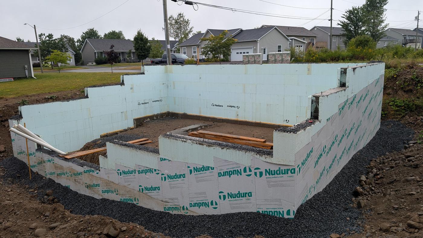 Insulated concrete form foundation walls poured and backfilled